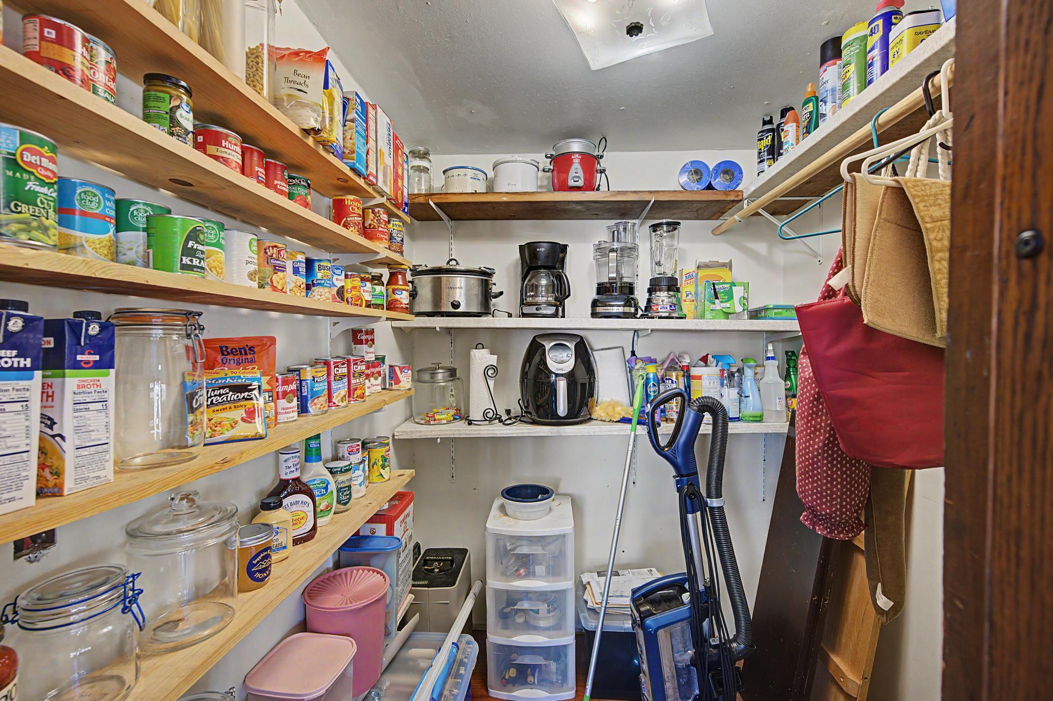 Unusual for classic farmhouses is the storage that this home offers, including this walk-in pantry adjacent to the kitchen