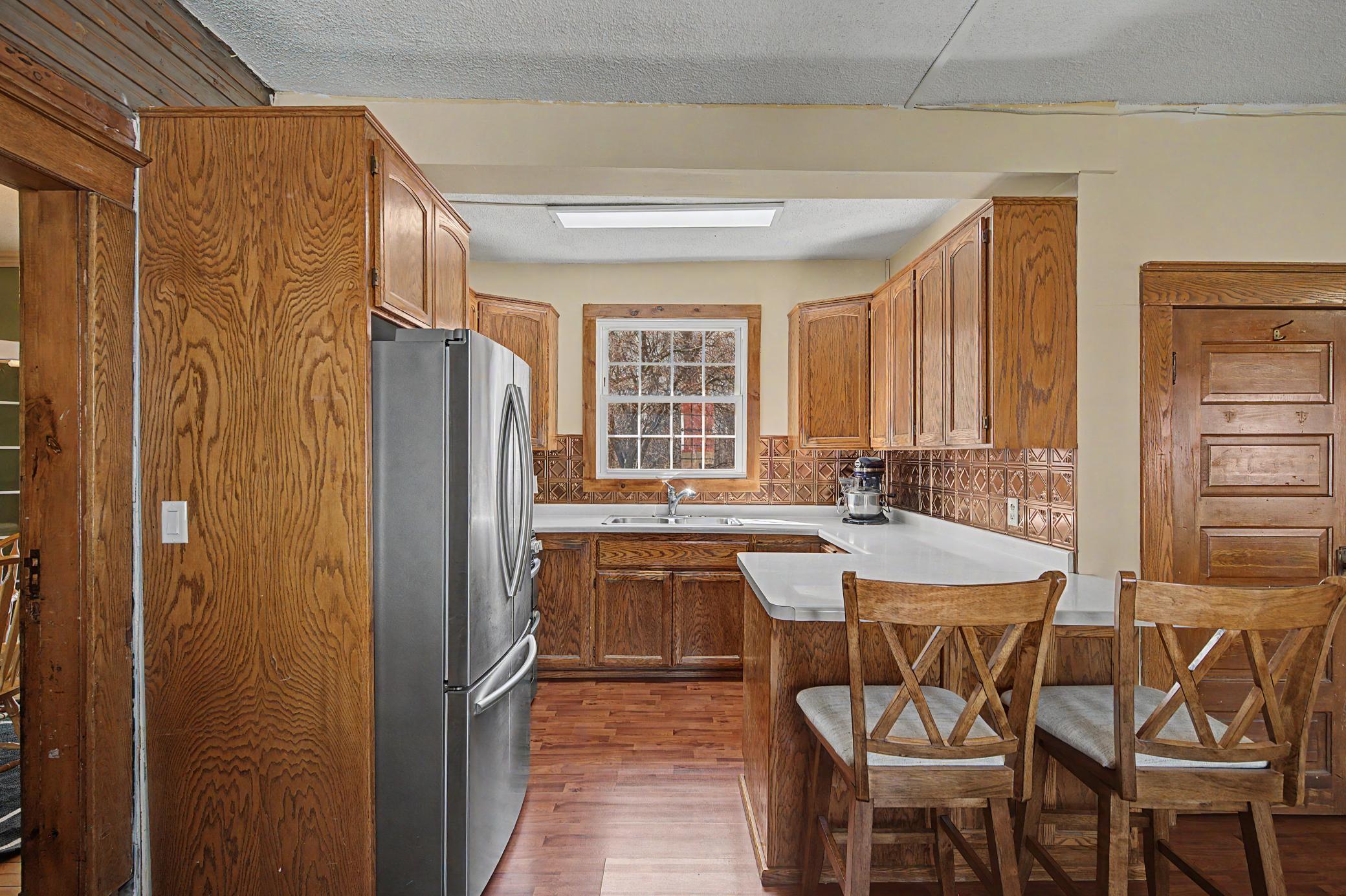 stainless steel appliance and warm wood tones compliment the sun lit kitchen with a window overlooking your back yard.