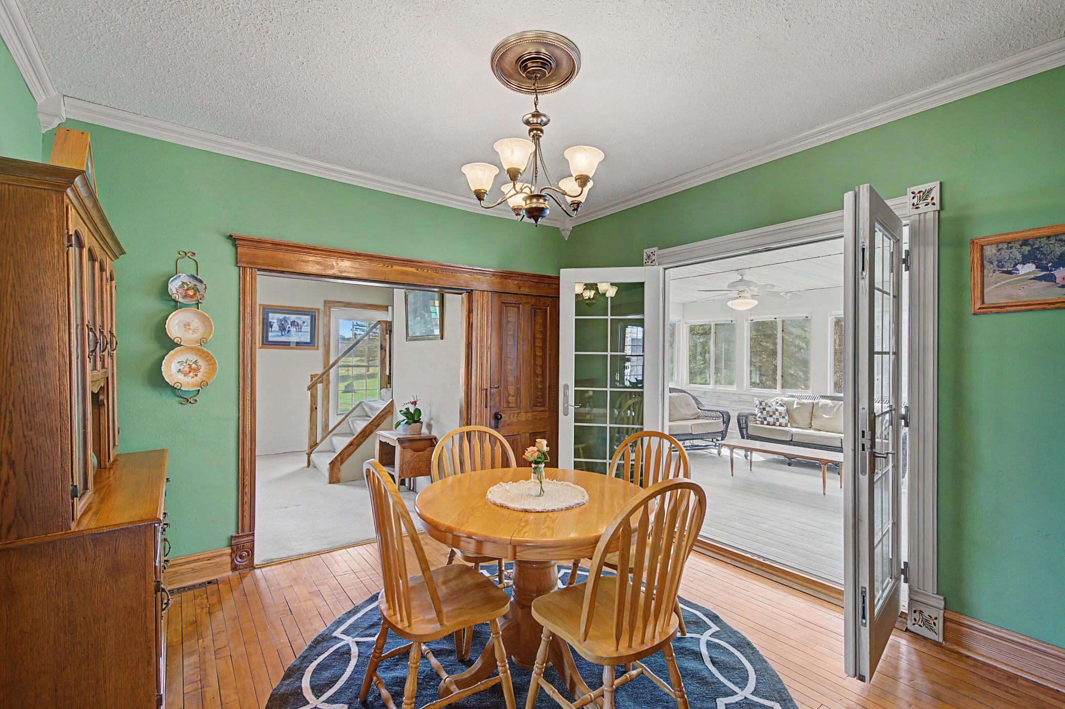 Formal dining room on the main has French doors which open to the screened porch and also connects to the family room, t