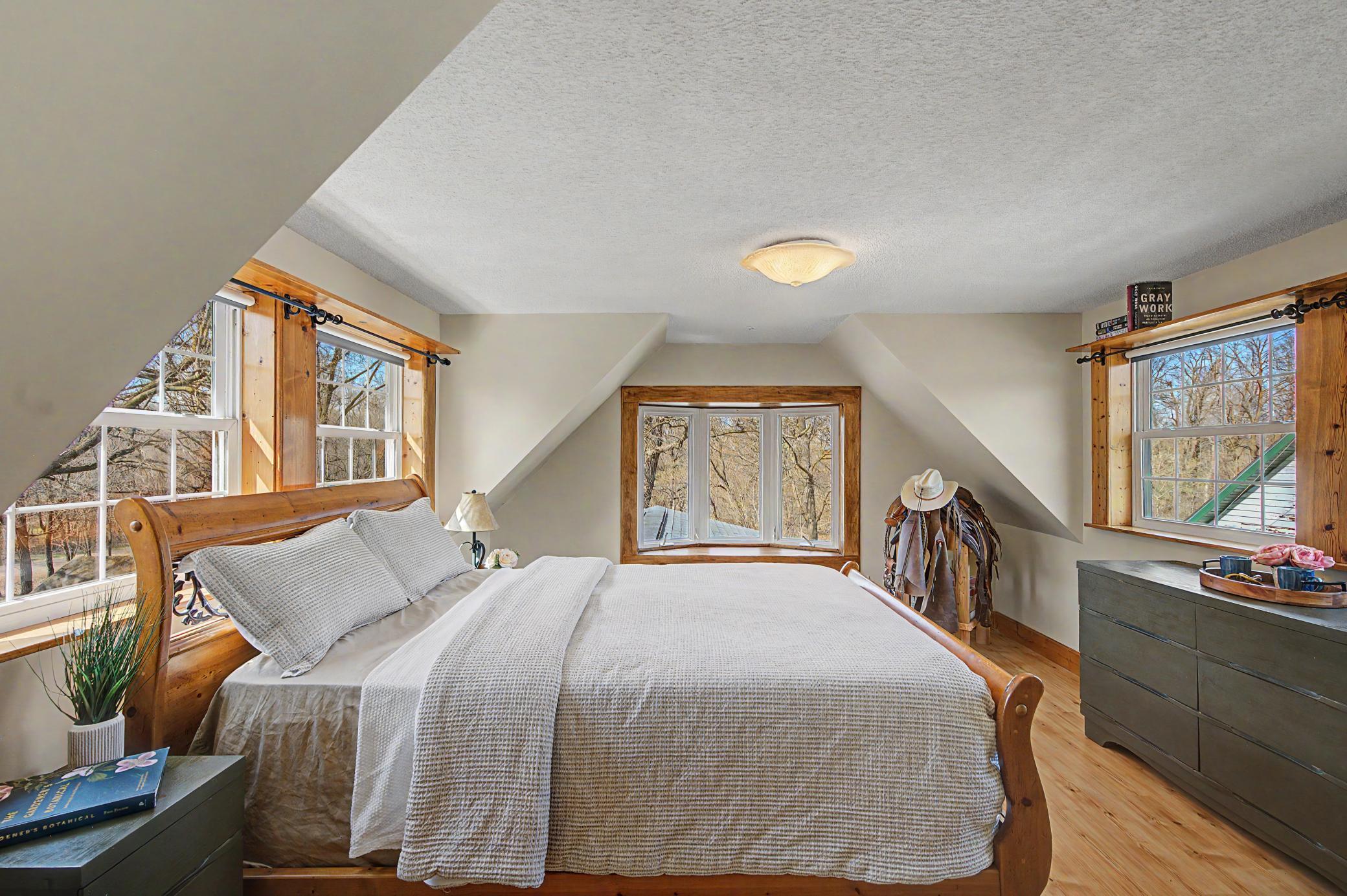 Escape to your sanctuary primary bedroom in the upper level with picturesque views out 3 windows