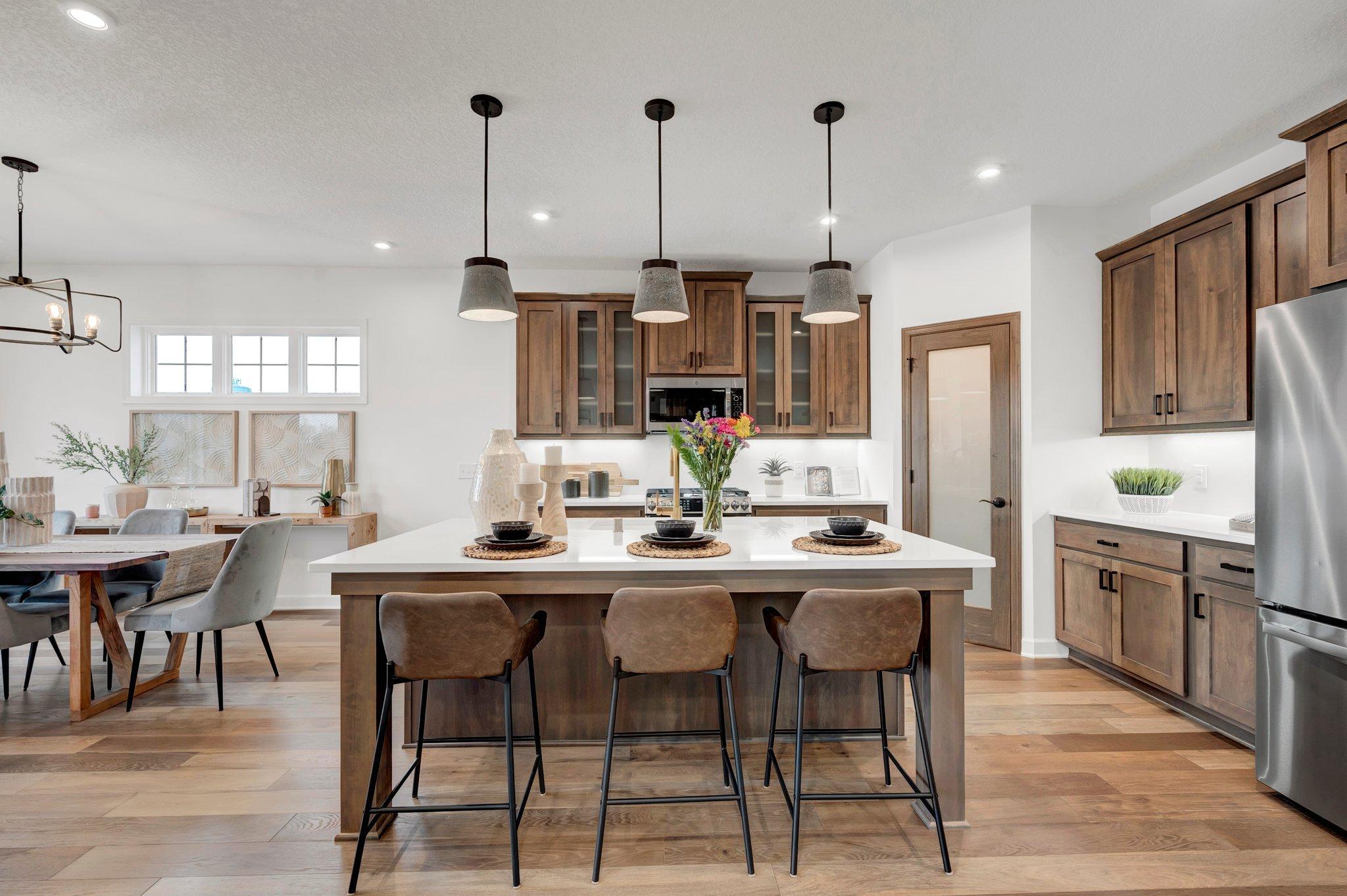 More than just a kitchen, this space pulls you in, with a central island that becomes the go-to spot from morning to night - *Photo of model home, options and design selections may vary
