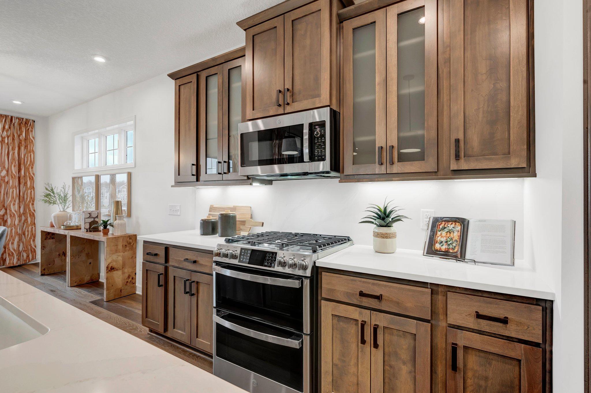 Thoughtfully designed with rich finishes and a clean layout, this kitchen delivers a space that's both functional and refined - *Photo of model home, options and design selections may vary