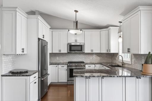 Beautifully reimagined kitchen with extended height shaker cabinetry with soft-close doors and drawers, slide-out shelving, lazy susans, and a wine glass rack.