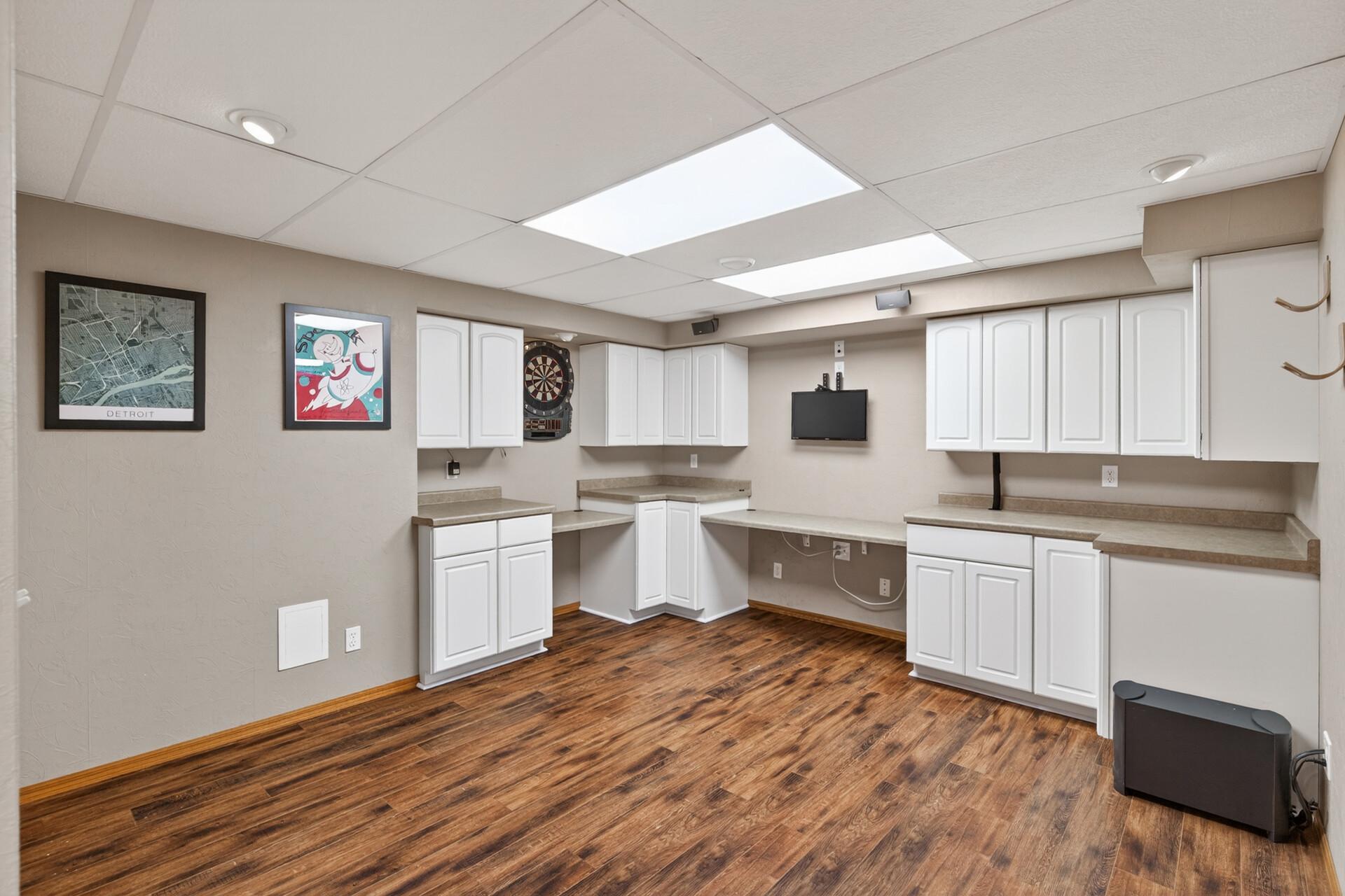 Lower level office/multi-purpose room with plenty of built-in storage. Bose high definition home theater/surround sound system, TV, and mounted dart board included.