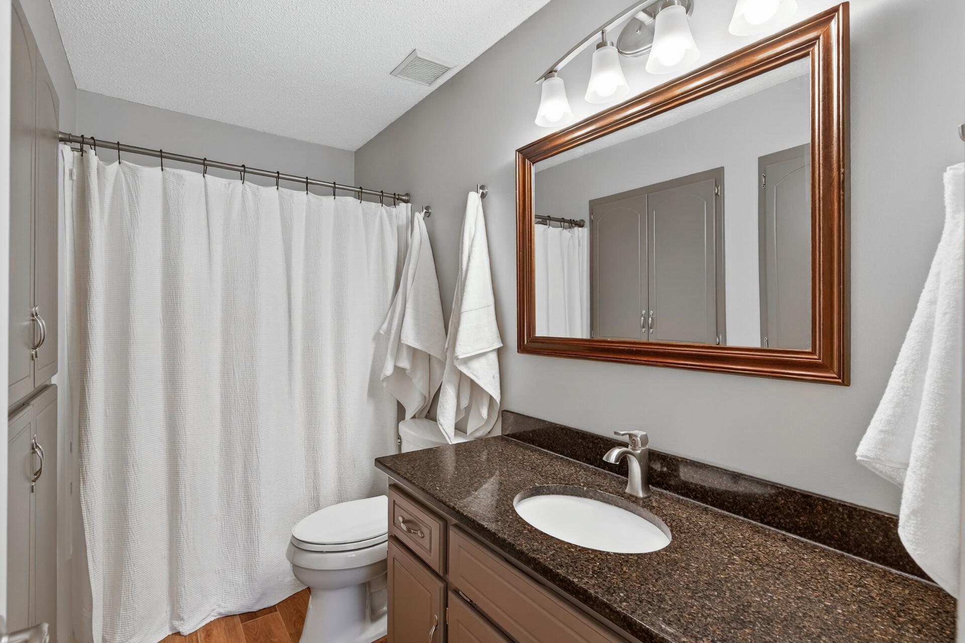 Beautifully updated upstairs bath with custom cabinetry.