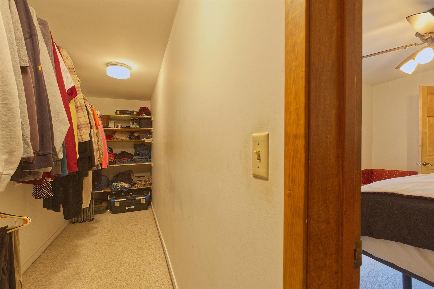 Primary bedroom walk in closet