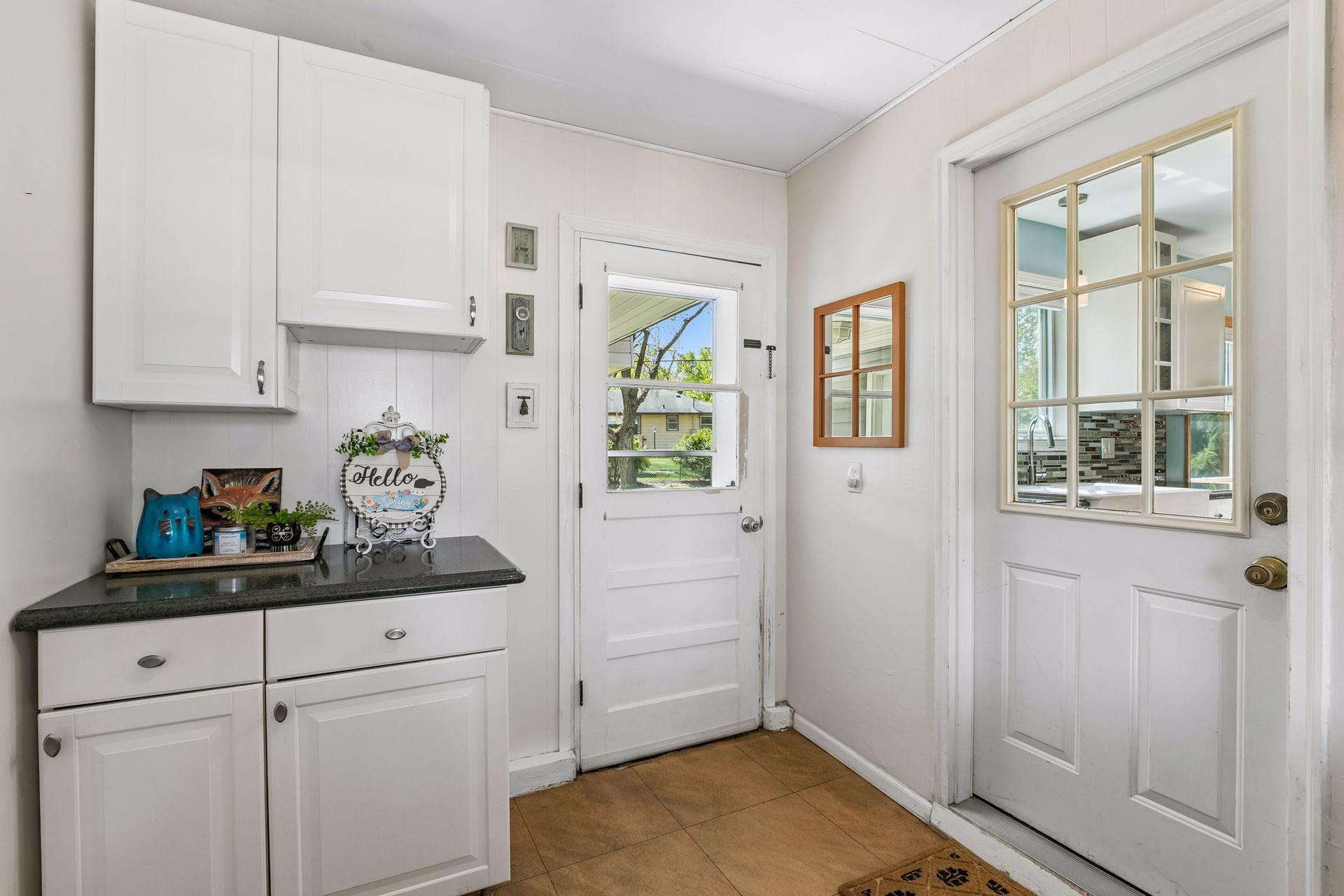 mudroom area between house and garage with access to backyard