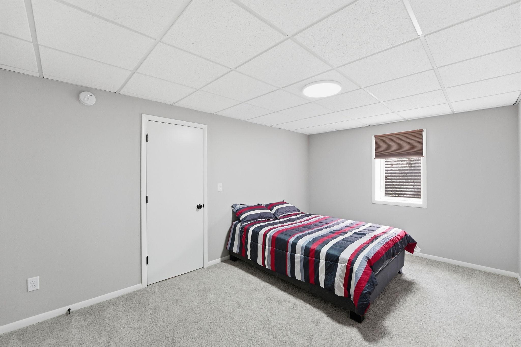 Lower level bedroom with egress window
