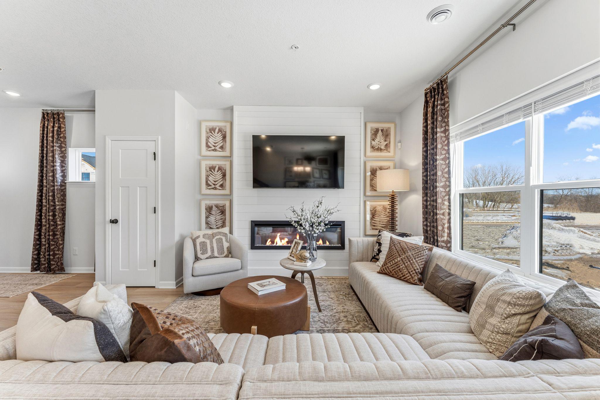 Family room features electric fireplace and blinds - for illustrative purposes only