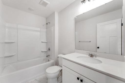 Full bathroom features black shower head, light fixtures and hardware - for illustrative purposes only