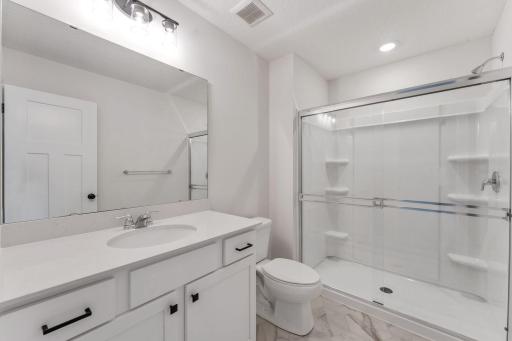 Owner's bathroom features black shower door, hardware and light fixture - for illustrative purposes only