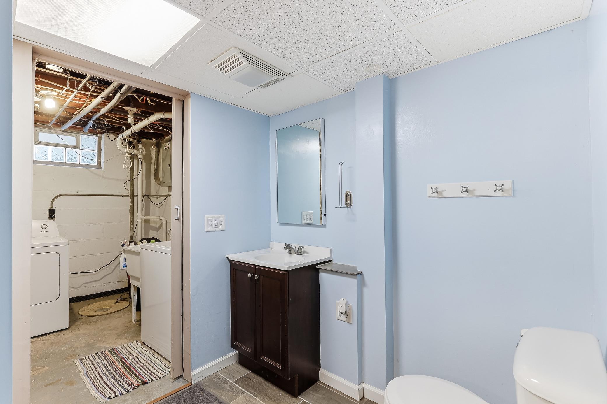 Lower level bathroom has access to laundry machines, but can be closed off too