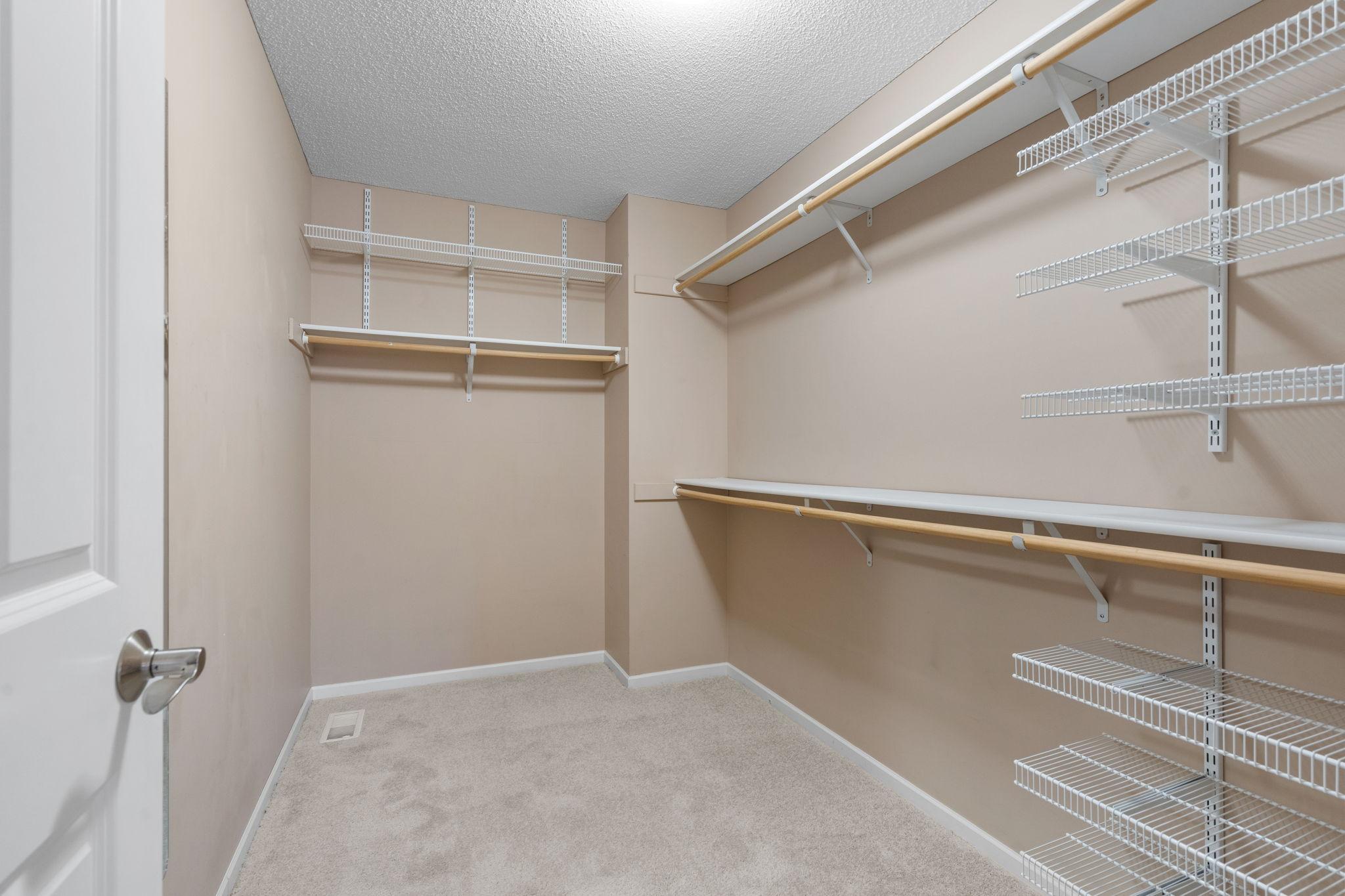 Large walk-in closet of primary bedroom