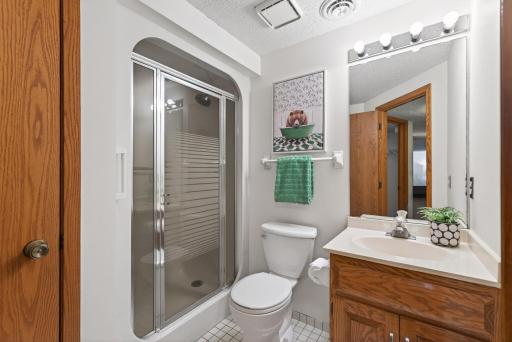 Lower level 3:4 bathroom hosts a convenient linen closet
