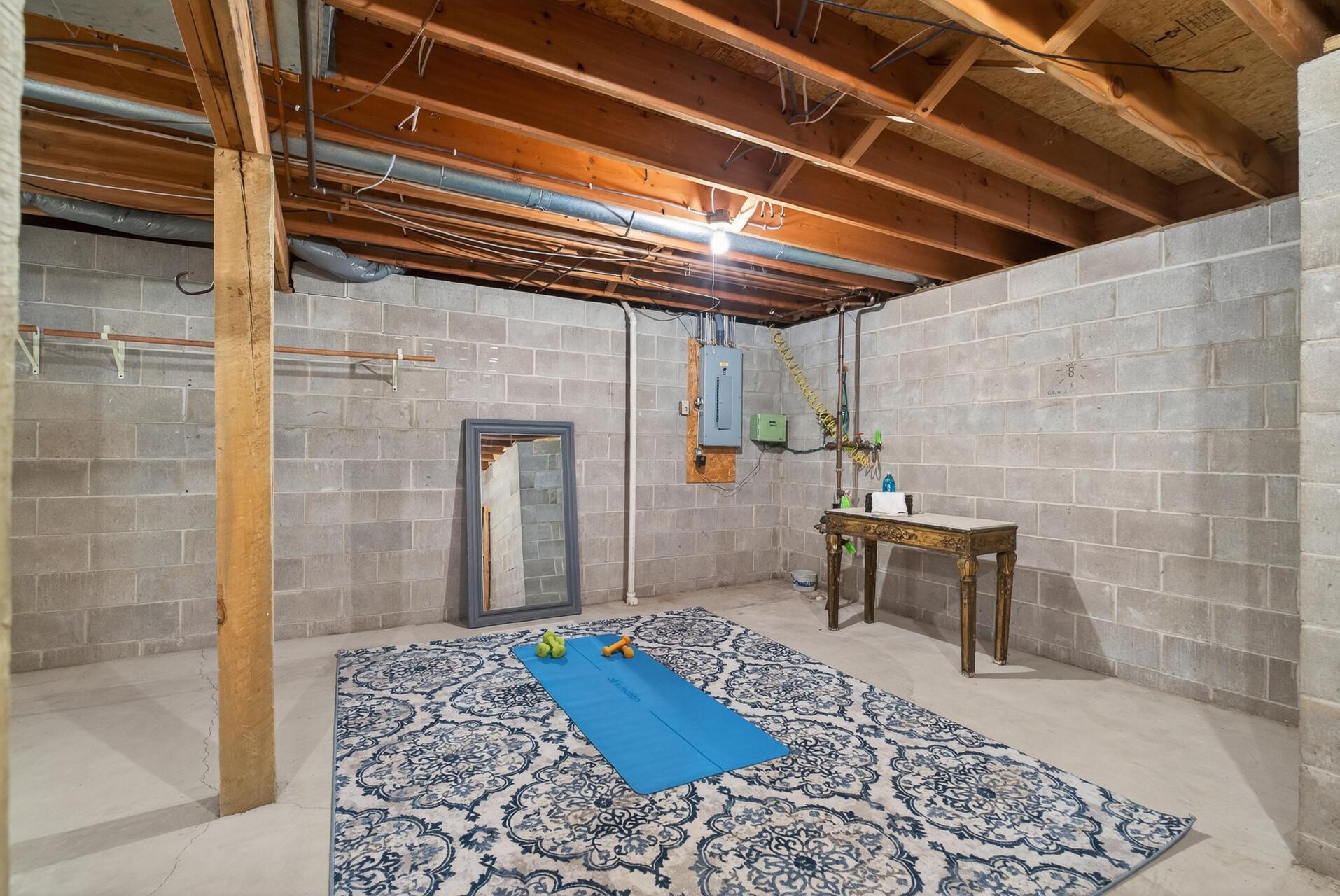 The unfinished basement area has potential for a home gym, storage or additional finished space