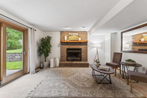 Family room features a wood burning fireplace