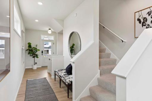 Unique wrap-around staircase. Photos and/or illustrations are of like home and may not depict actual home plan configurations. Features, materials and finishes may contain options that are not included in price.
