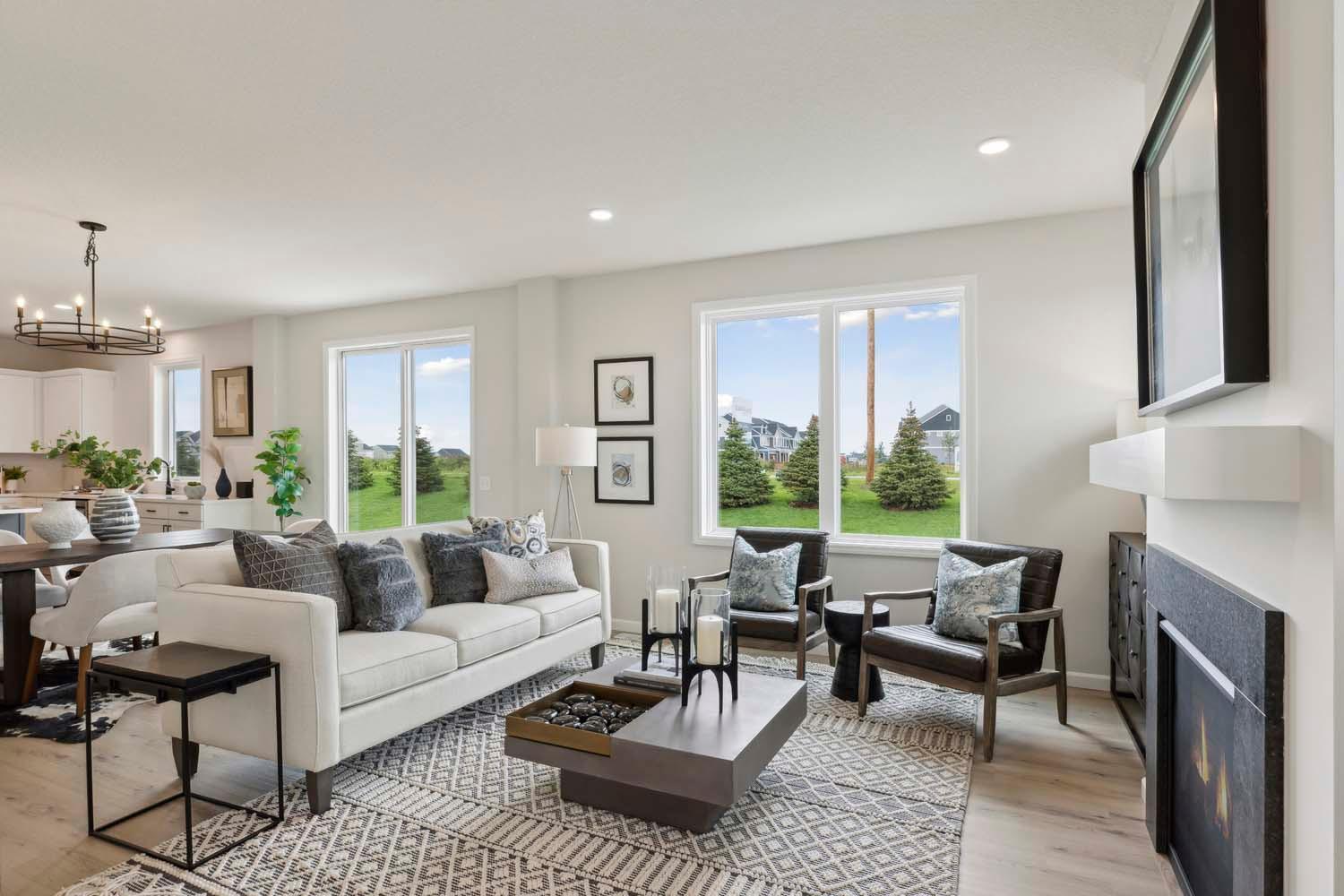 Open main floor gathering room. Photos and/or illustrations are of like home and may not depict actual home plan configurations. Features, materials and finishes may contain options that are not included in price.