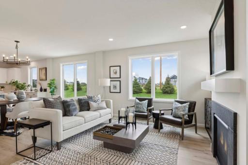 Open main floor gathering room. Photos and/or illustrations are of like home and may not depict actual home plan configurations. Features, materials and finishes may contain options that are not included in price.