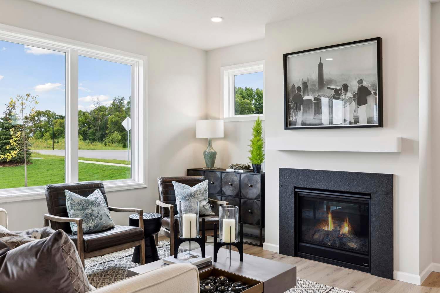 Family room features gas fireplace. Photos and/or illustrations are of like home and may not depict actual home plan configurations. Features, materials and finishes may contain options that are not included in price.