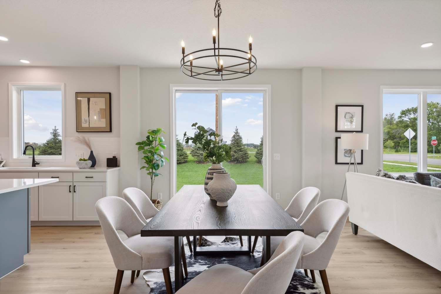 Large dining room. Photos and/or illustrations are of like home and may not depict actual home plan configurations. Features, materials and finishes may contain options that are not included in price.