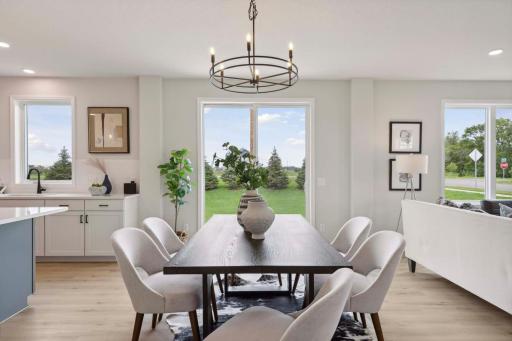 Large dining room. Photos and/or illustrations are of like home and may not depict actual home plan configurations. Features, materials and finishes may contain options that are not included in price.