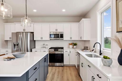 Window over kitchen sink overlooks backyard. Photos &/or illustrations are of like home & may not depict actual home plan configurations. Features, materials & finishes may contain options that are not included in price.