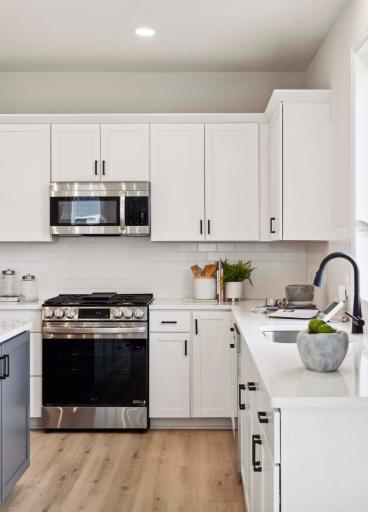 Sleek gas slide-in range. Photos and/or illustrations are of like home and may not depict actual home plan configurations. Features, materials and finishes may contain options that are not included in price.