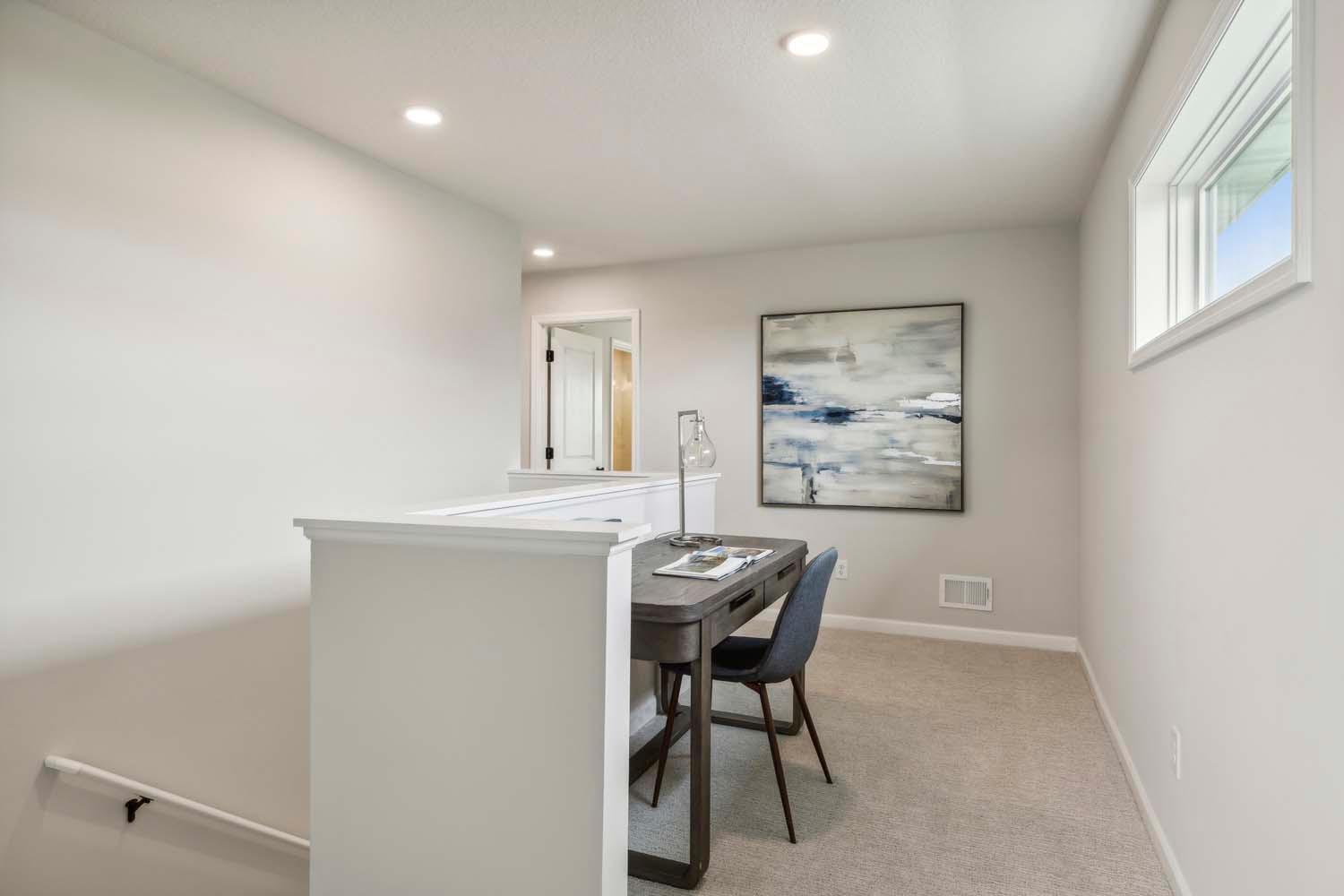 Separate work space at top of second floor landing open to loft. Photos and/or illustrations are of like home and may not depict actual home plan configurations. Features, materials and finishes may contain options that are not included in price.