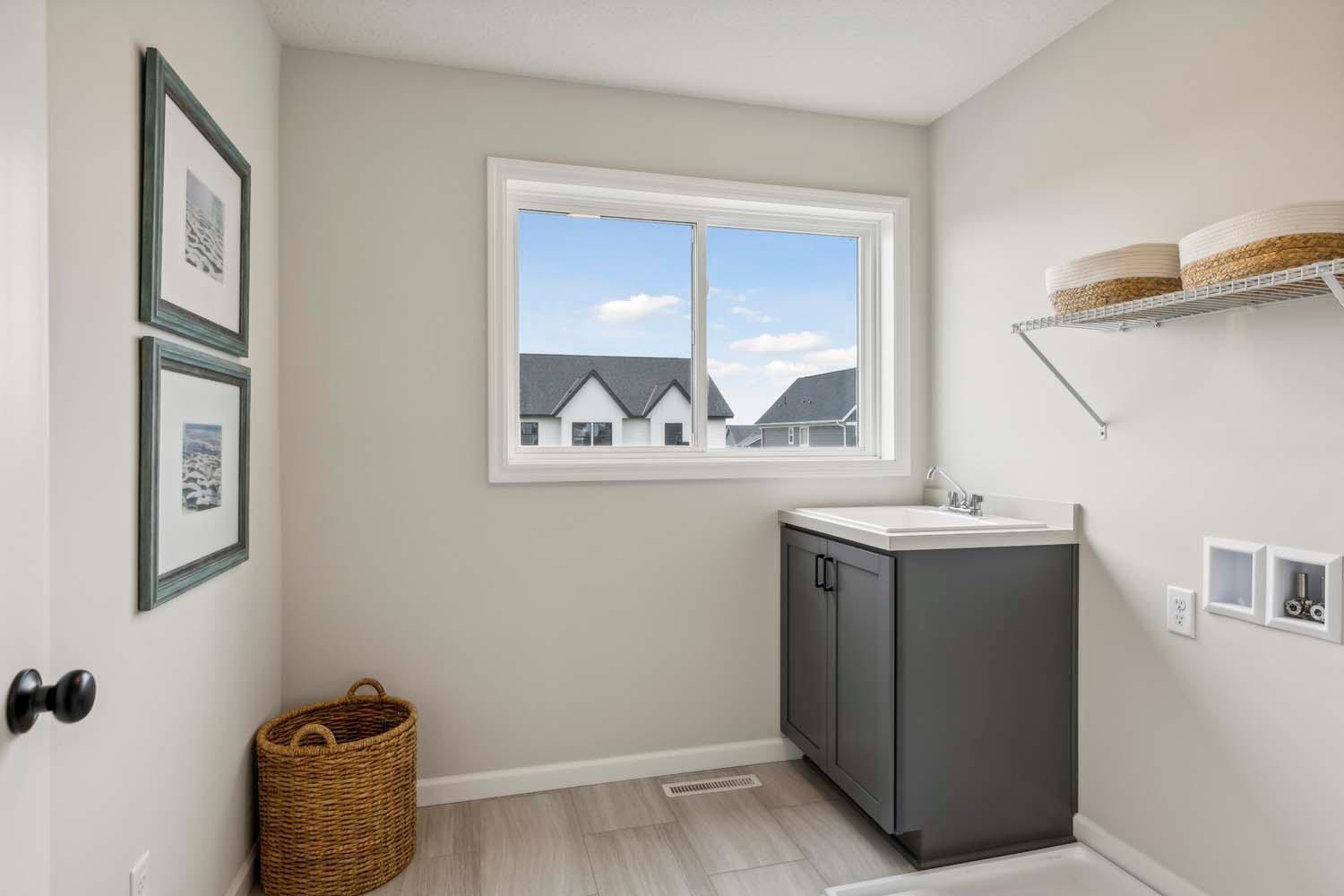 Second floor laundry includes laundry sink and cabinet. Photos and/or illustrations are of like home and may not depict actual home plan configurations. Features, materials and finishes may contain options that are not included in price.