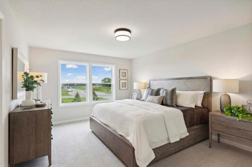 Primary suite includes large window. Photos and/or illustrations are of like home and may not depict actual home plan configurations. Features, materials and finishes may contain options that are not included in price.