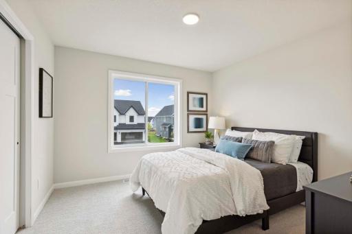 One of four bedrooms. Photos and/or illustrations are of like home and may not depict actual home plan configurations. Features, materials and finishes may contain options that are not included in price.