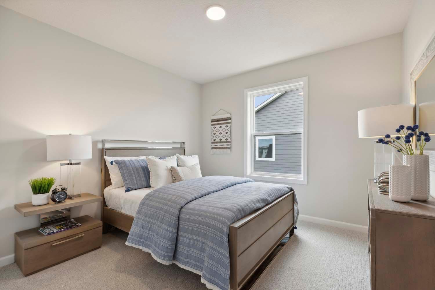 One of four bedrooms. Photos and/or illustrations are of like home and may not depict actual home plan configurations. Features, materials and finishes may contain options that are not included in price.