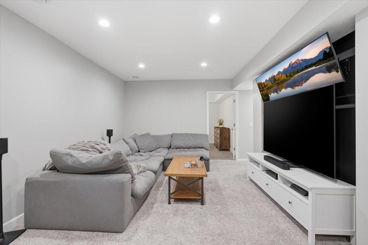 In the lower level of the home, you will find the absolute best spot for movie or game night. Tall ceilings and recessed lighting make this space as welcoming as the front sitting room.