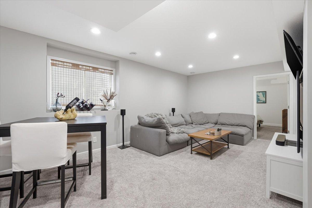 A large egress window allows natural light to soak into the space, inviting all to gather.