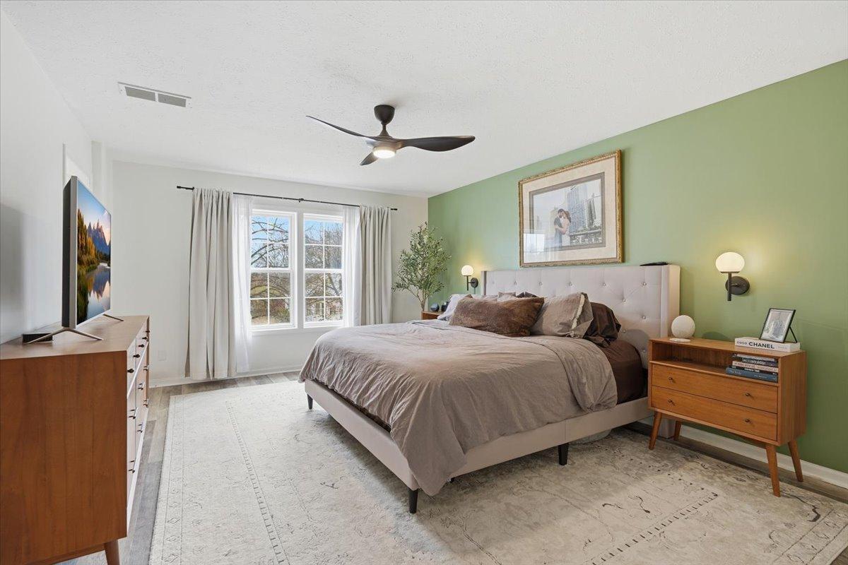 The upper level features 4 bedrooms on the same level! Here you can see the expansive, yet cozy primary suite.