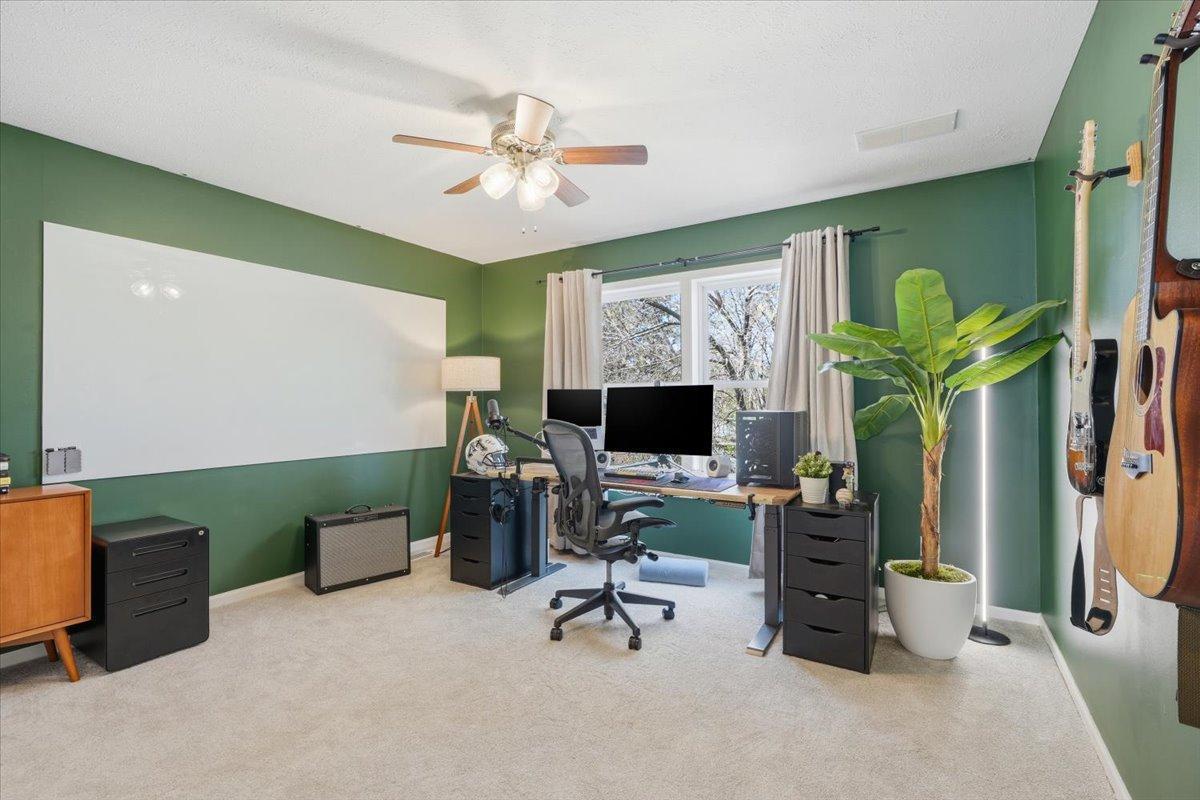Across the hall you will find the second upper level bedroom that is currently used as an office. The large whiteboard will remain with the home!