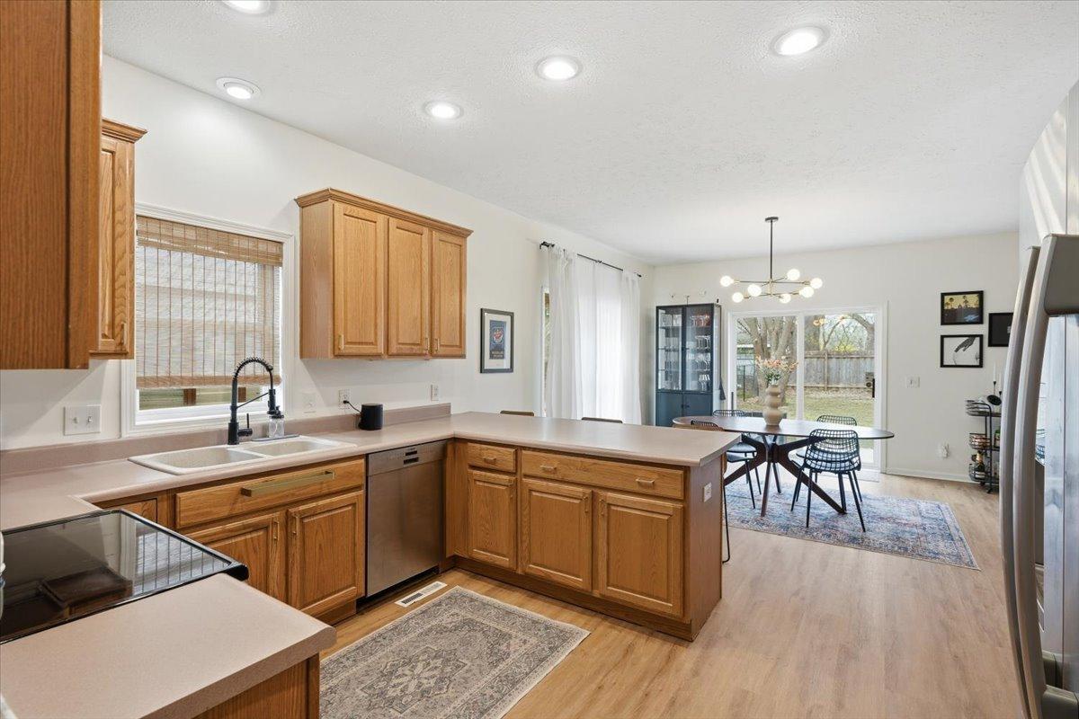 Updated cabinet pulls, faucet and light fixtures elevate the kitchen and dining room. The perfect space to tackle meal prep.
