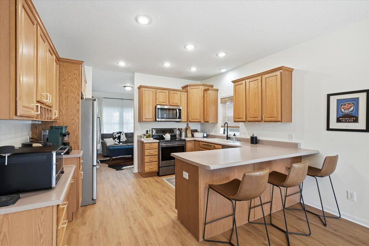 The kitchen offers clean stainless steel appliances, ample counter space, and plenty of storage space for your favorite cooking gadgets.