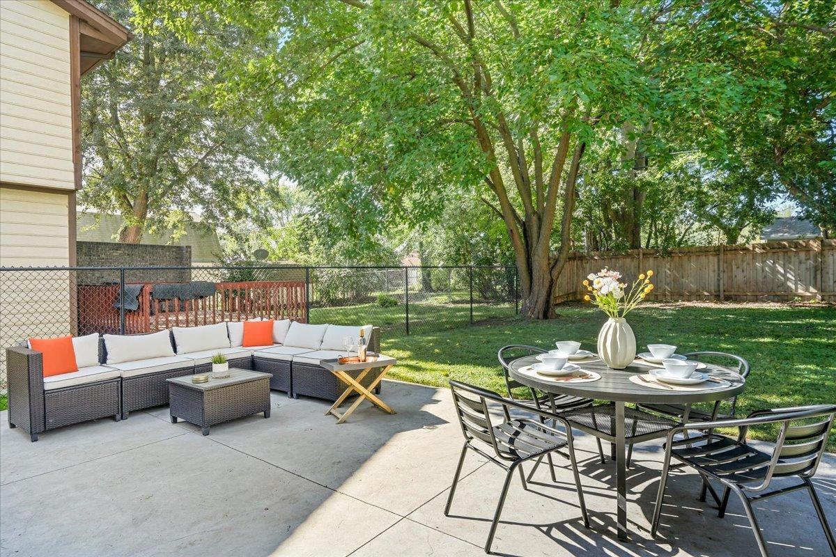 Off the dining room, you will find a large stamped concrete patio that offers a retreat in the fully fenced backyard.
