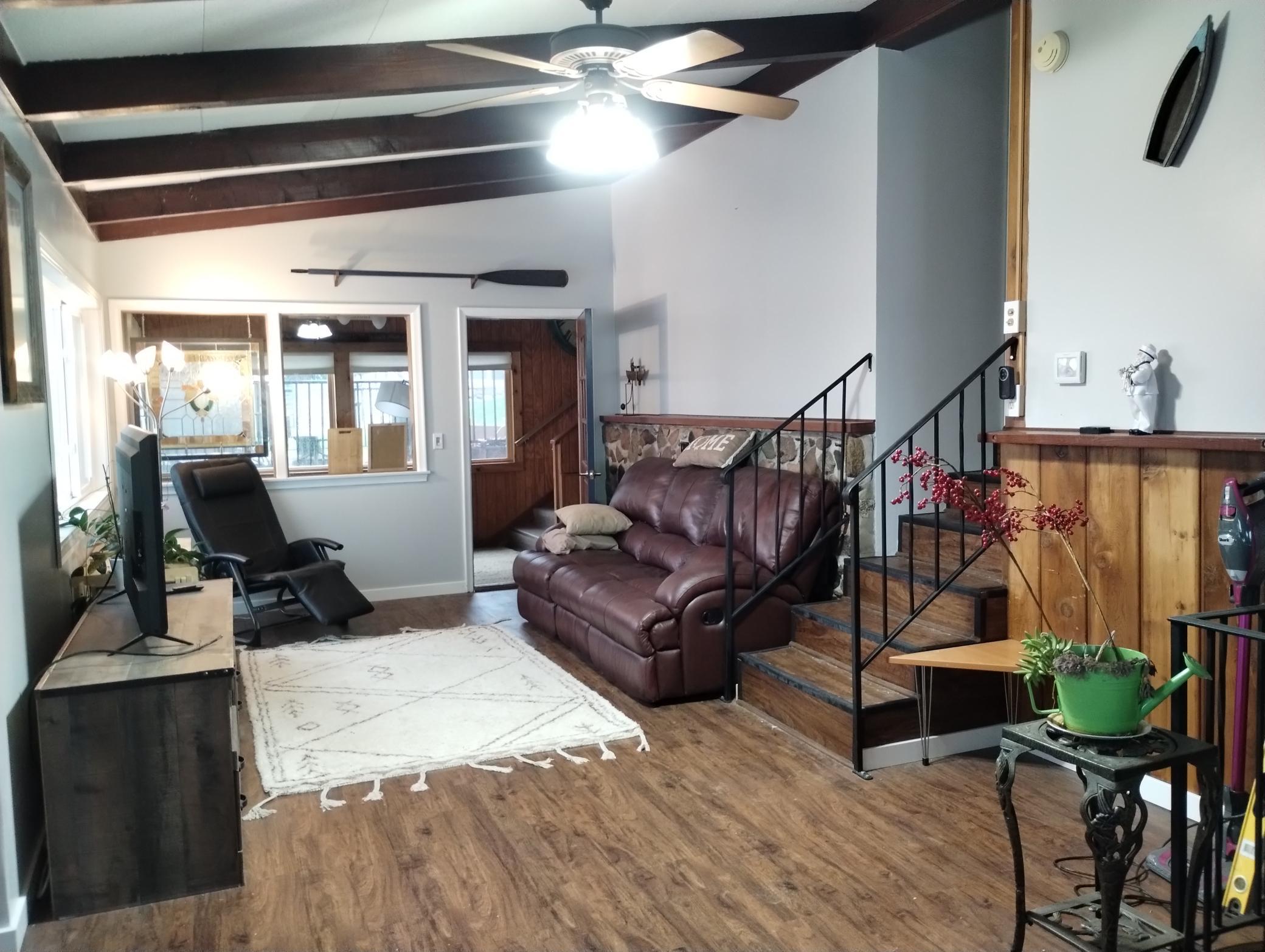 Living room with stairs to Bedrooms and Bathroom