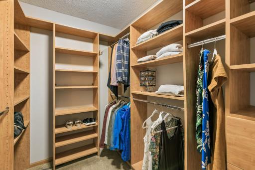 Primary walk-in-closet with built-in cabinetry