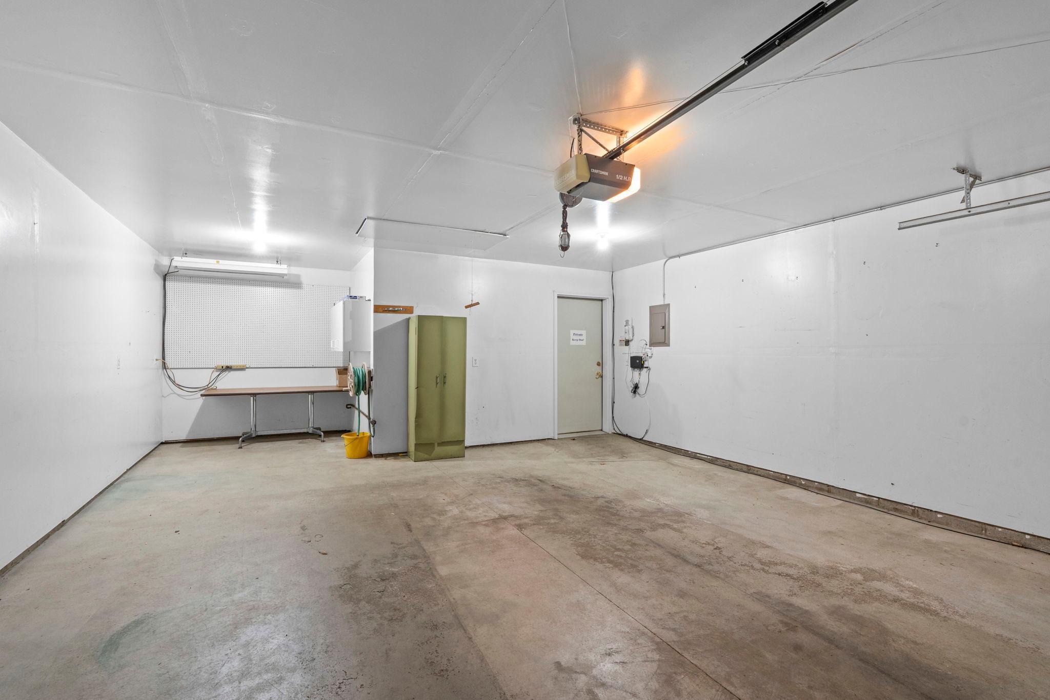 The garage offers extra storage space at the rear, along with convenient pull-down ladder access to additional overhead storage.
