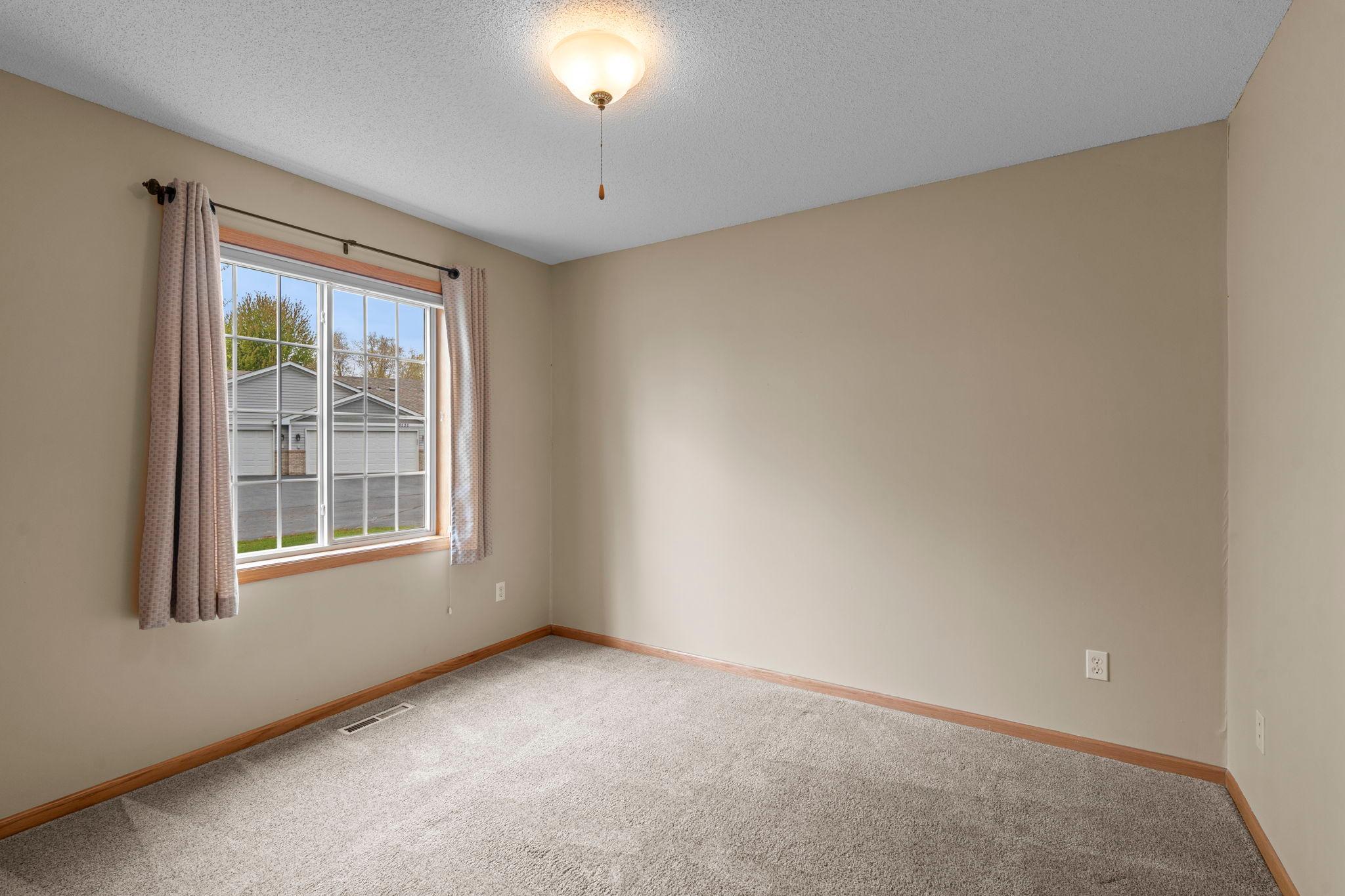 Bedroom #2 is thoughtfully positioned on the opposite side of the living room from the primary, offering added privacy for guests.