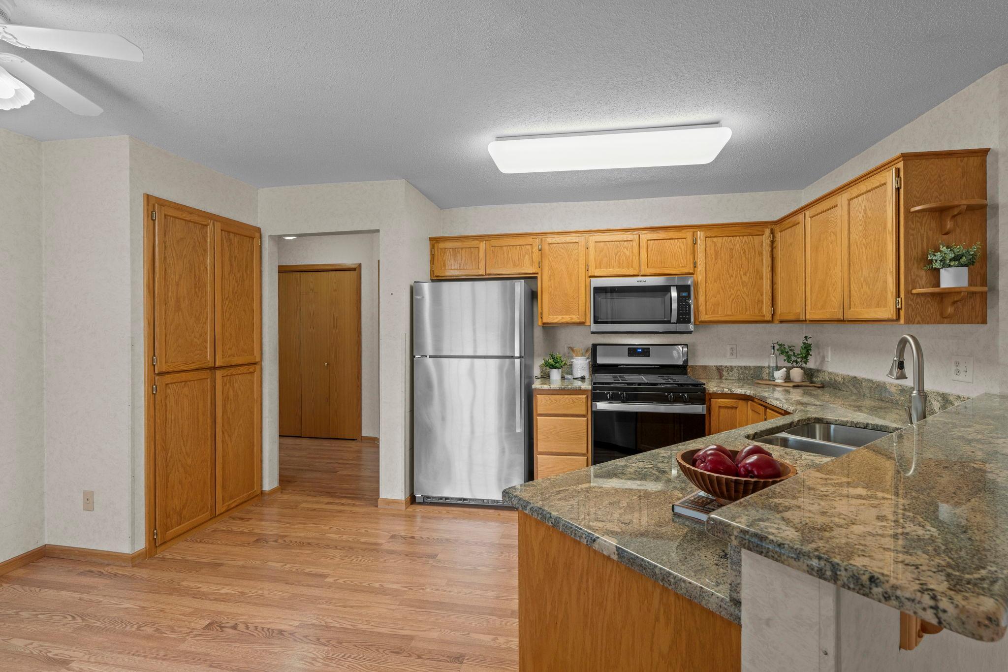 Stainless appliances, large pantry cabinet and granite counters make the kitchen shine.