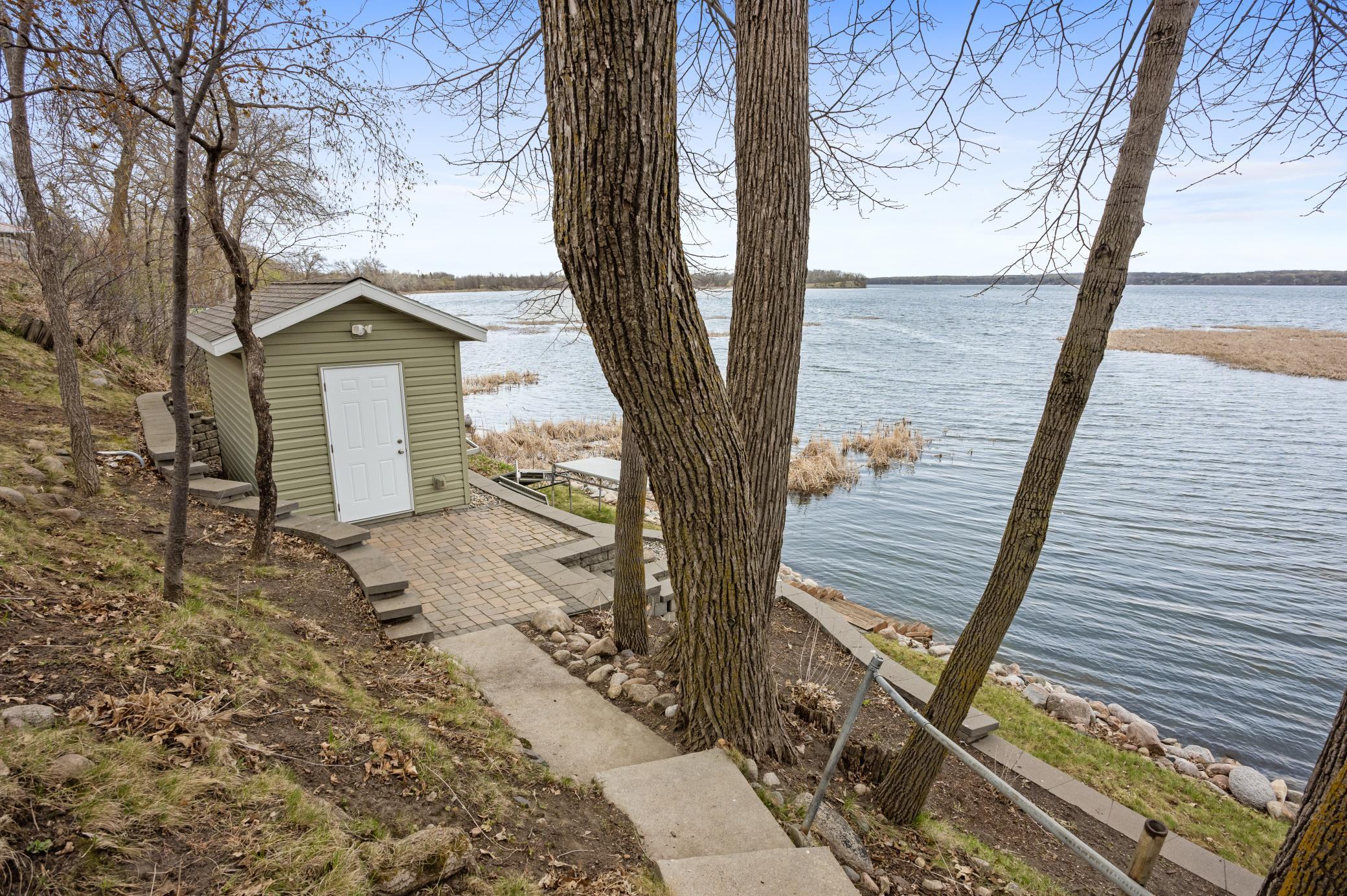 Beautifully designed steps & patio leading to the brand-new shed. Turn this into a bunk house or entertaining space lakeside.