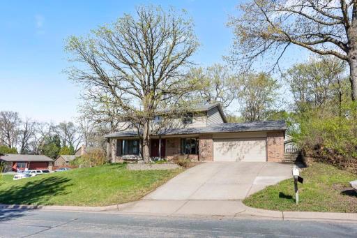 Classic two-story exterior with mature trees, spacious yard, and cul-de-sac setting.