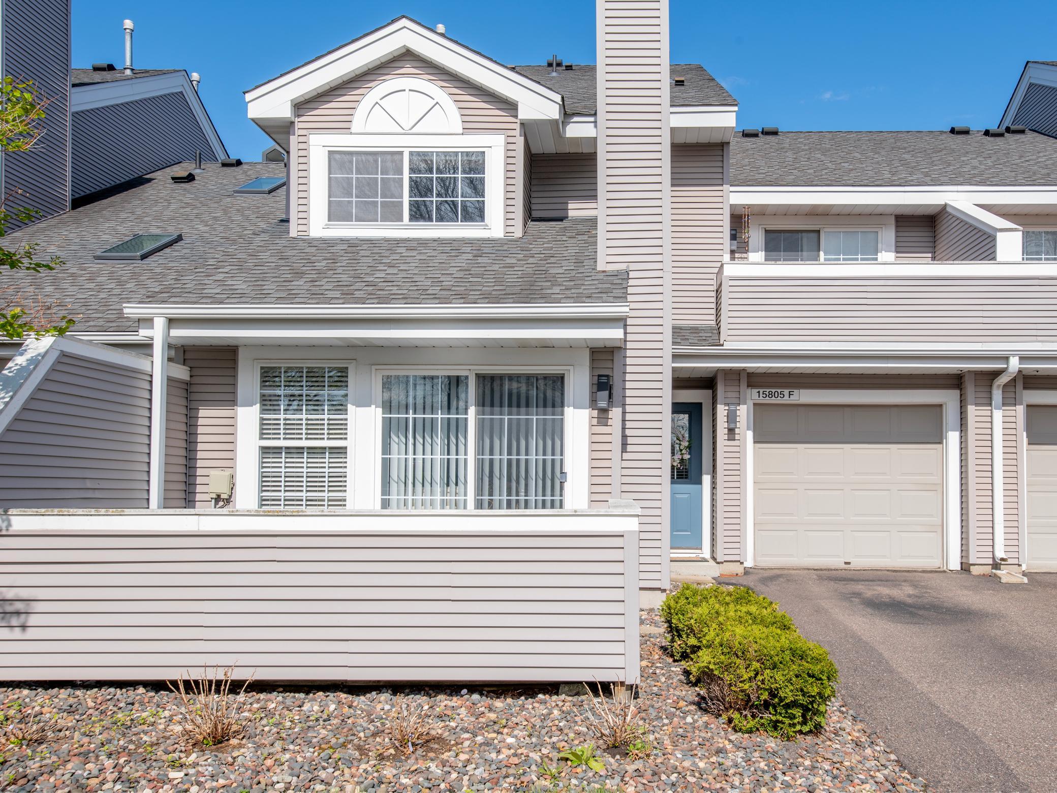 Beautiful two bedroom townhome in convenient location. This front view of townhome features two separate decks, one on main level and one upper level. Walking trails just outside guest parking area.