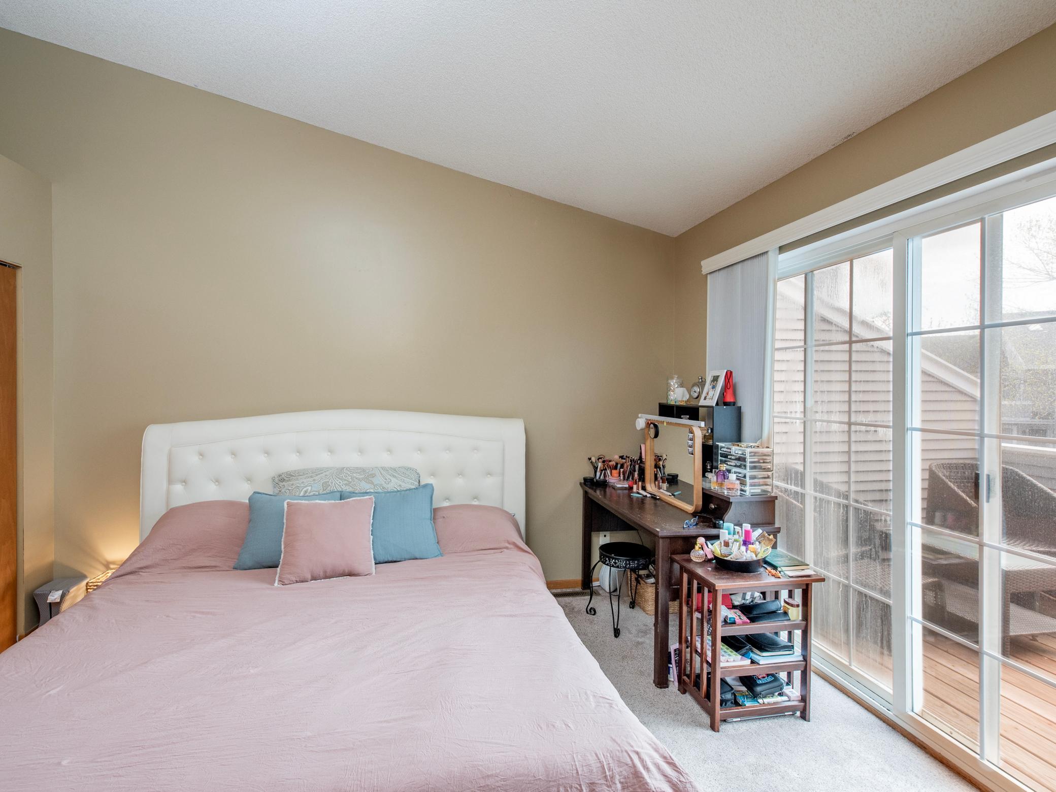 Primary bedroom with slider patio door to upper level deck.