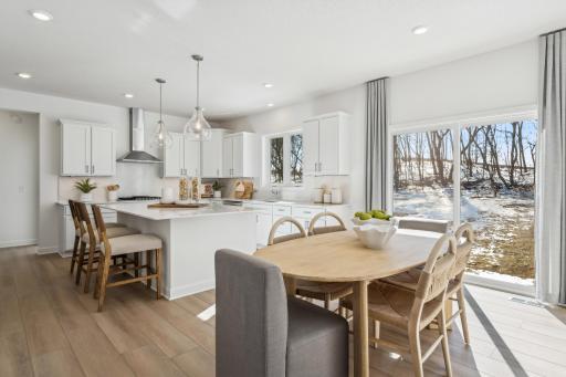 Soaked in natural sunlight, the homes eat-in dining room has ample space for a dining table located in the heart of the home. (Photo is of the actual home.)